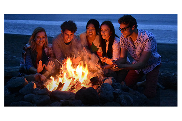 Some trendy folks around a fire